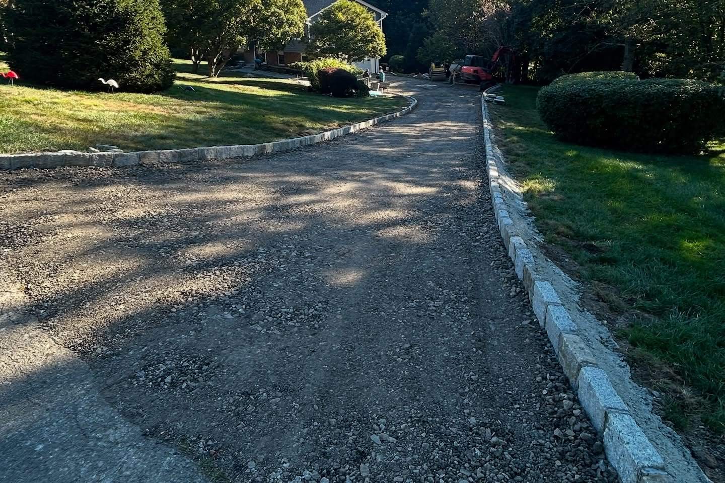 A long residential drive edged with a granite curb, a Luxuriad project